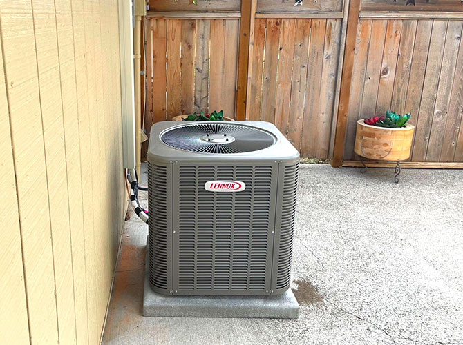 Air conditioner replacement next to a home